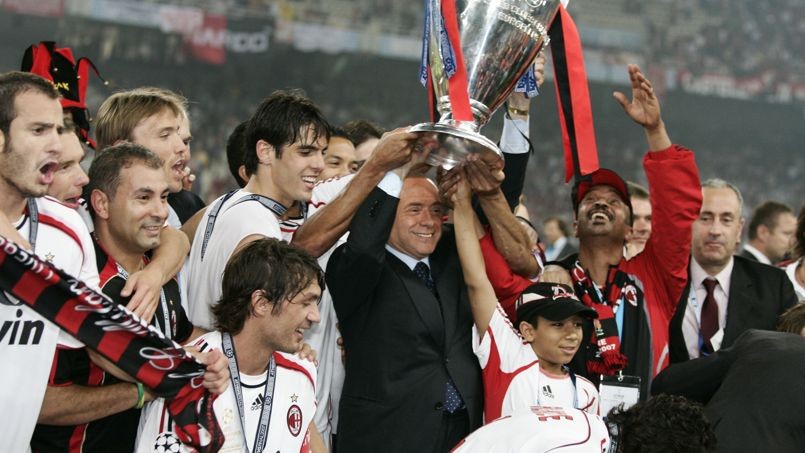 Former Italian PM and AC Milan President Berlusconi holds the cup while celebrating the team's victory in Athens