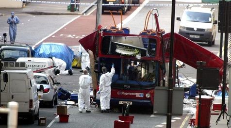 555153-police-and-forensic-experts-continue-to-gather-clues-near-the-bomb-destroyed-bus-in-central-london