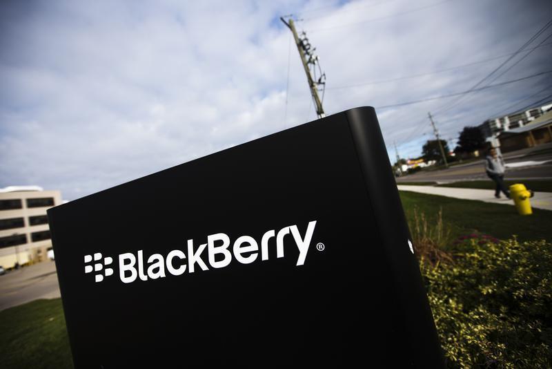 A man walks by a Blackberry sign at the Blackberry campus in Waterloo