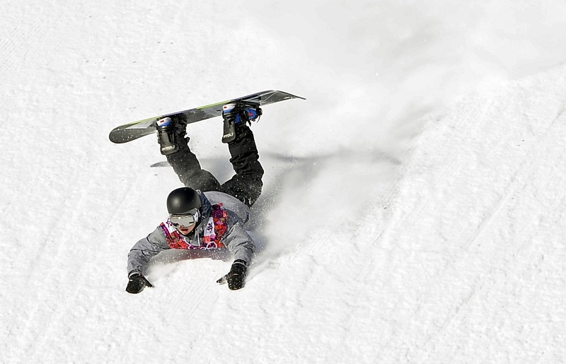 Austria's Mathias Weissenbacher crashes during the men's slopestyle snowboarding qualifying session at the 2014 Sochi Olympic Games in Rosa Khutor