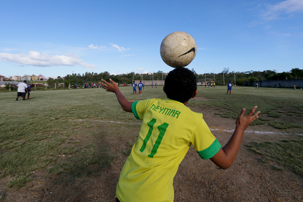 A boy wears a national soccer team jersey with the name of striker Neymar on it in Porto Alegre