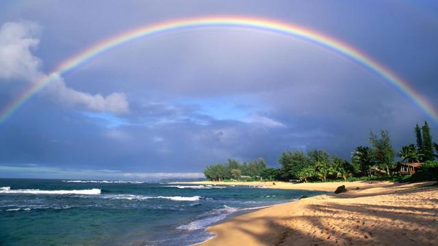 Double rainbow and evening light on beach. Kauai Island. Hawaii. USA